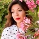 Profile image of Anne Wallace with pink flowers background